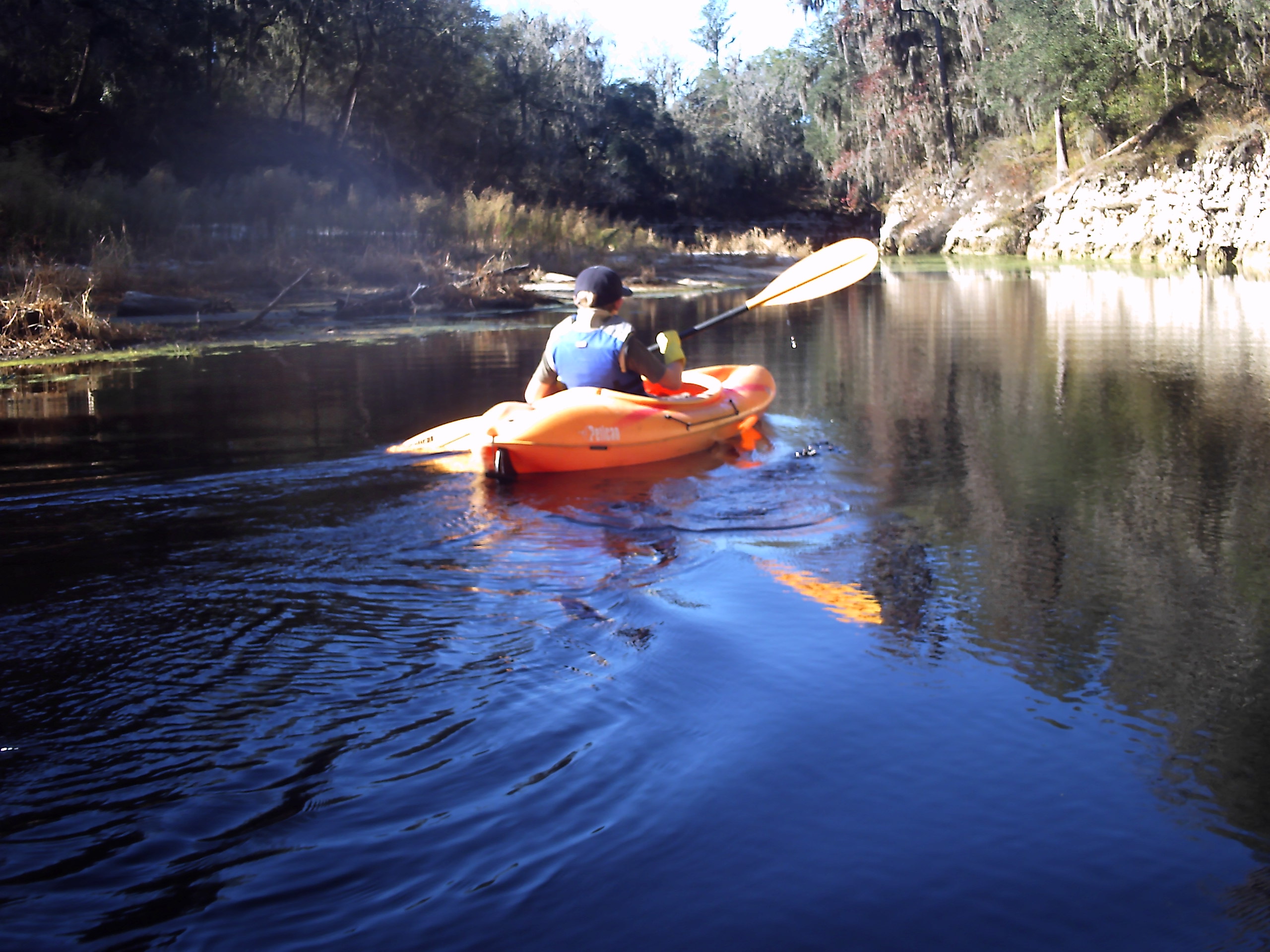 Mason paddles down the river.